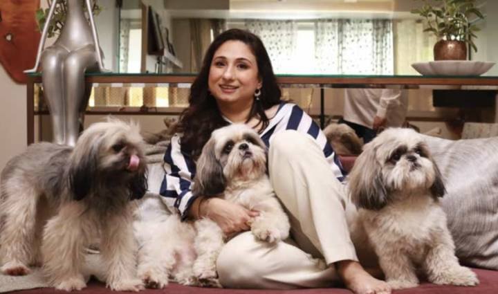 Sheetal Dewan Kapur at home on a sofa with her three dogs